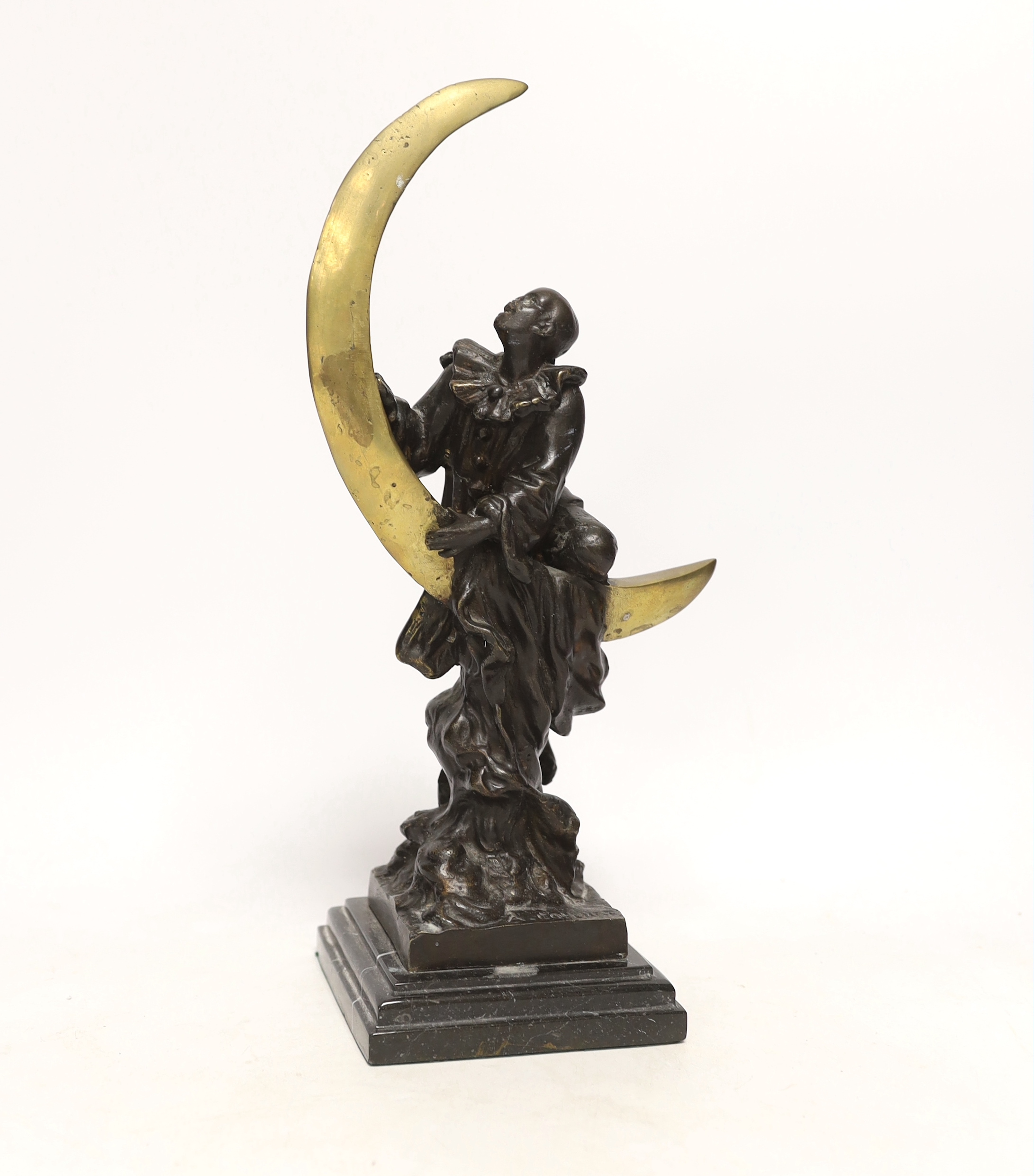 After Claire Colinet (1885-1972), a bronze study of a Pierrot and crescent moon, raised on stepped marble base, 33cm high